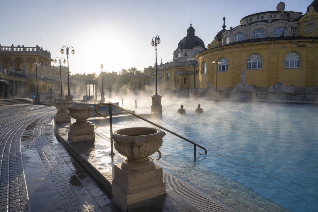 Nearly empty outdoor thermal pool at a Budapest bath just after opening on a weekday morning