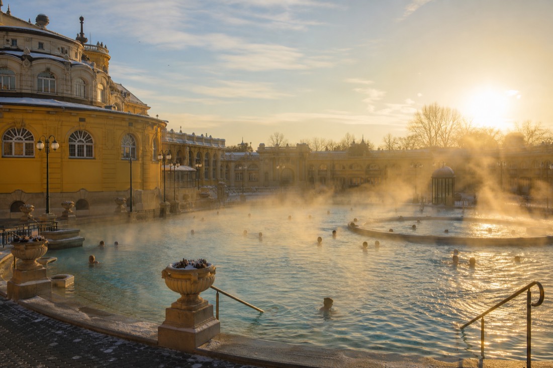 Grand bath courtyard with steaming pools and winter light in Budapest