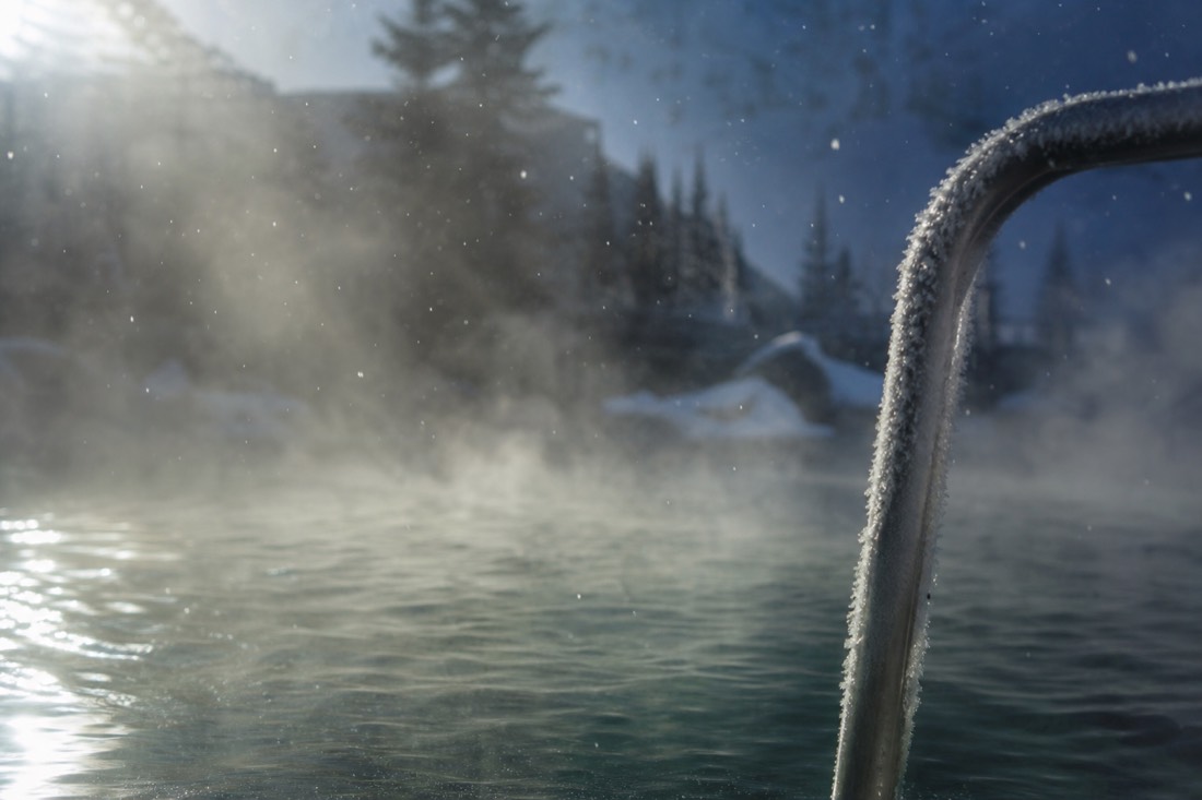 Steam and frost above hot spa water outdoors in Budapest during winter