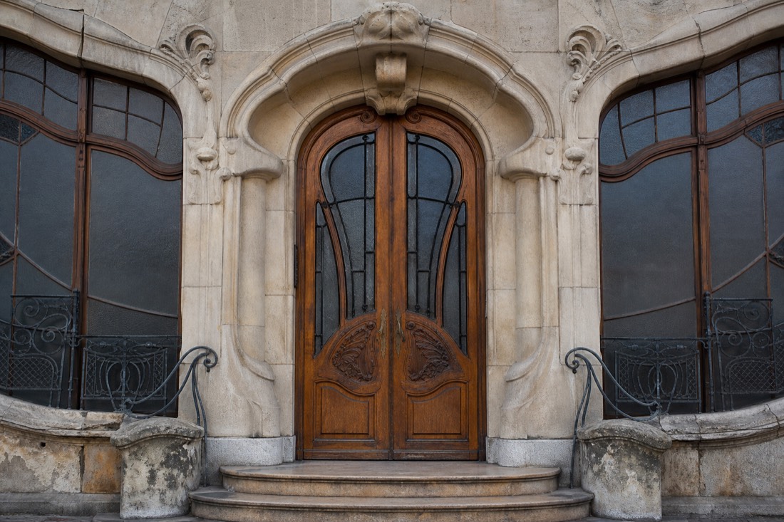 Closed ornate entrance doors of a historic Art Nouveau bath building in Budapest