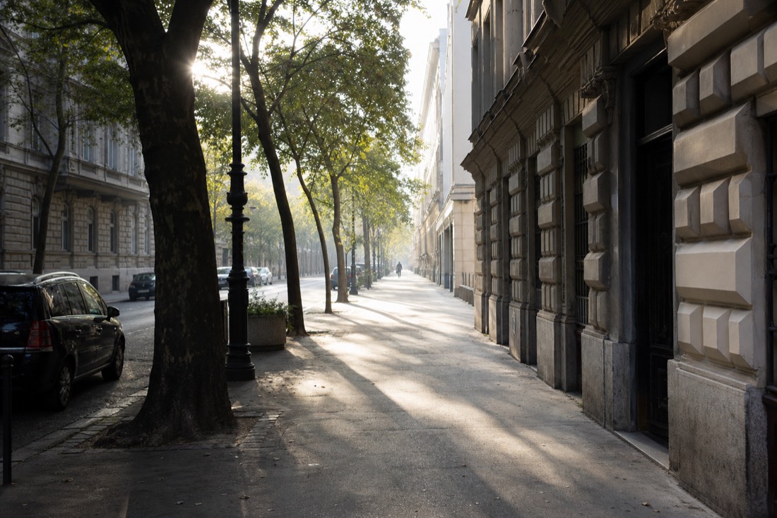 Quiet Budapest street near City Park in early morning light, a short walk from the thermal bath